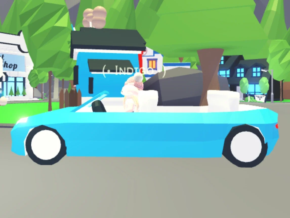 A player driving the Limo, an open-top car, along an Adoption Island street in Adopt Me